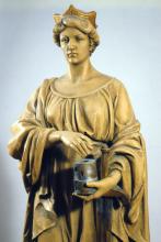 Die heilige Barbara legt ihre rechte Hand über Turm und Schwert.